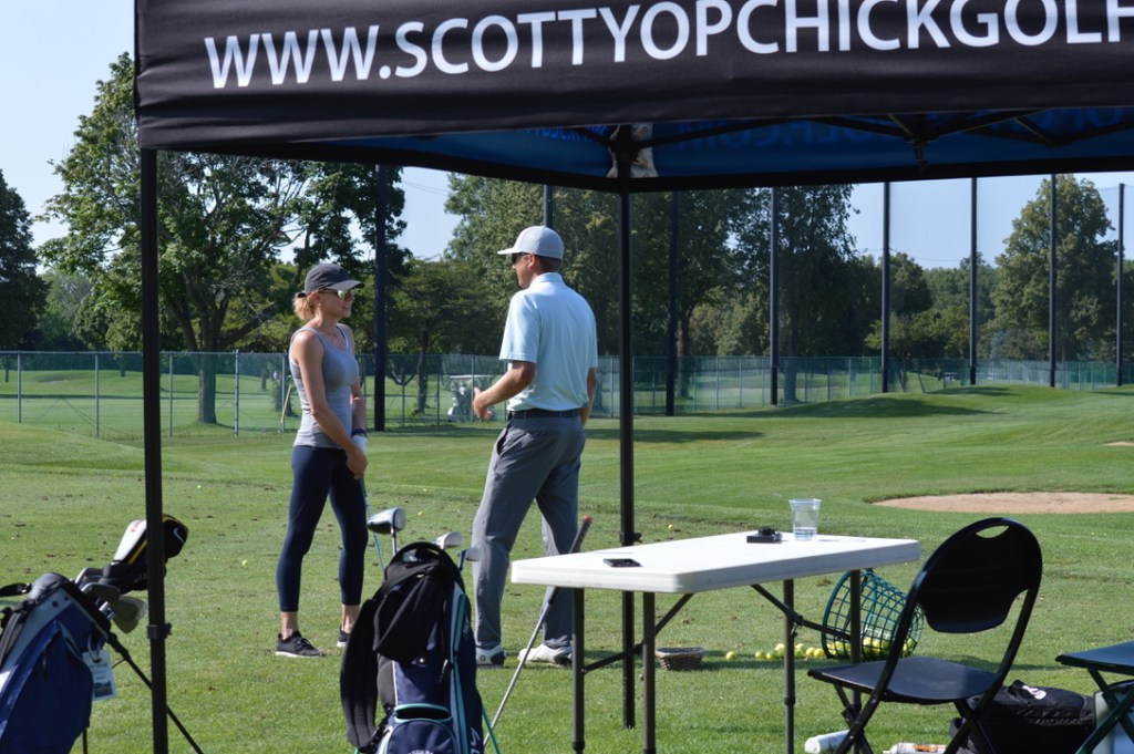 golf instructor teaching a student on the course