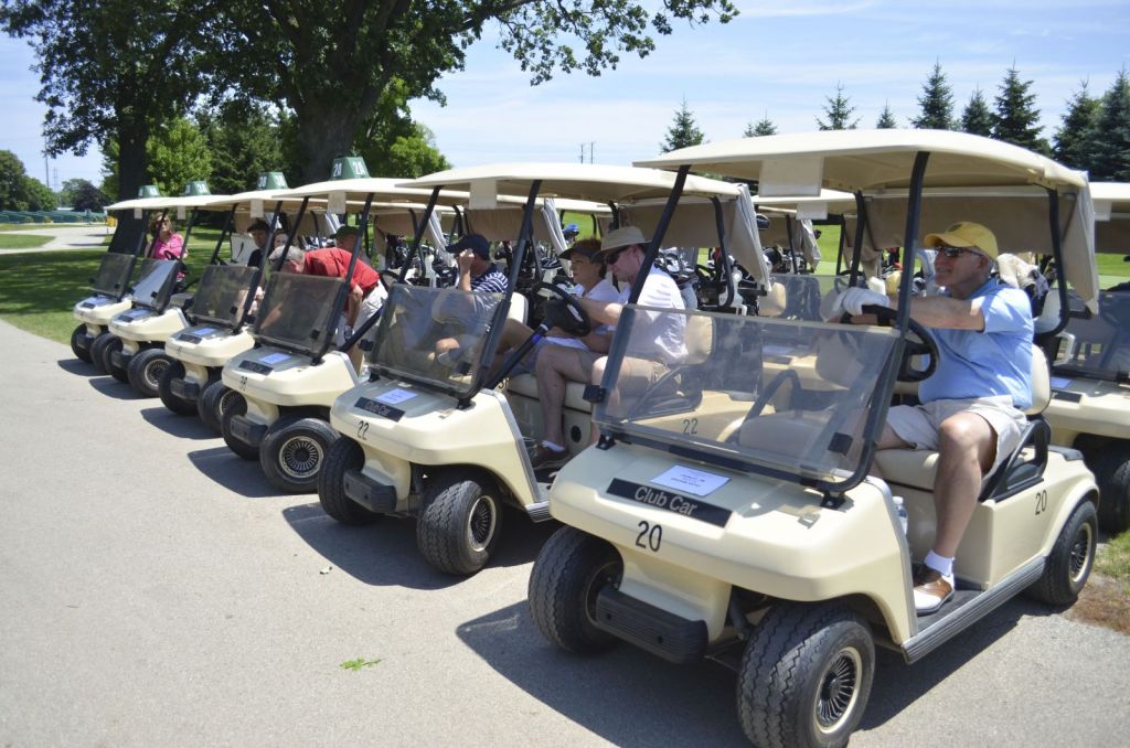 golfers on carts ready for event